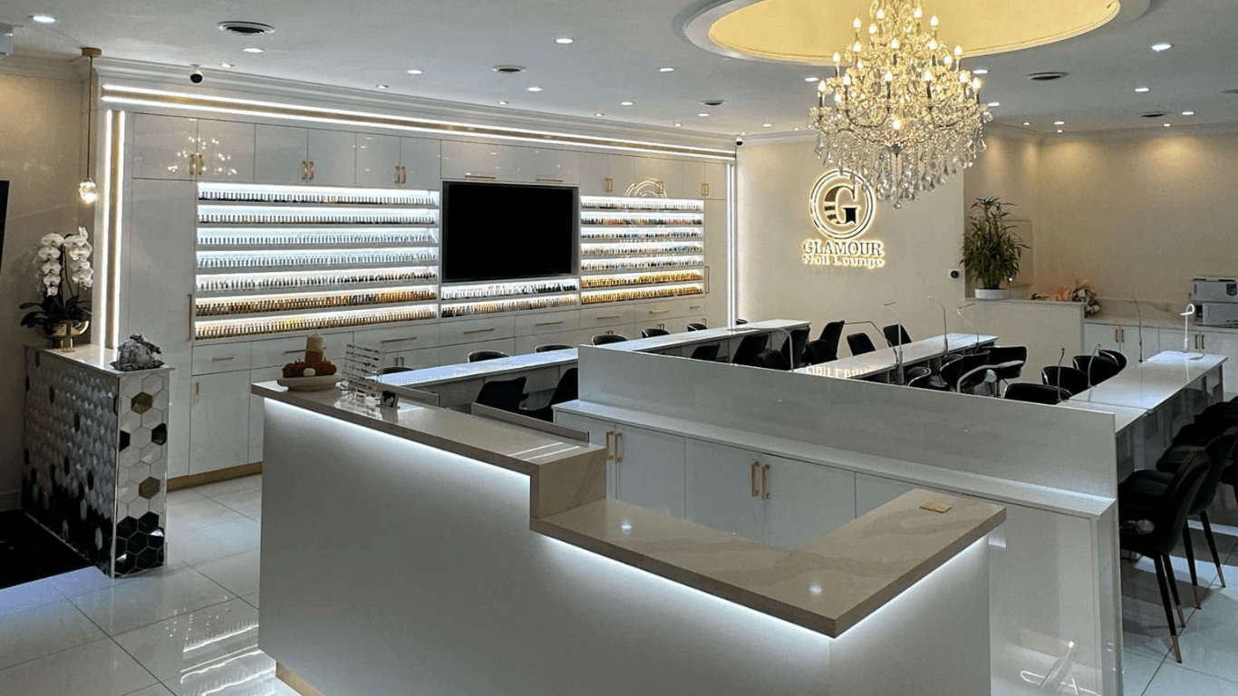 Glamour Nail Lounge luxury salon interior with crystal chandeliers, marble counters, and gold accents